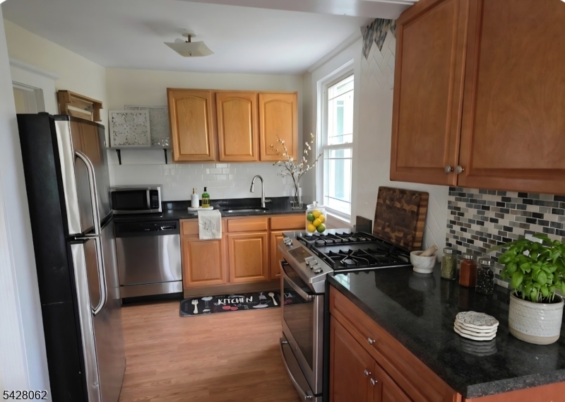 71 Montclair Avenue Montclair, NJ 07042 - Photo 6 of 25 a kitchen with sink a refrigerator and microwave