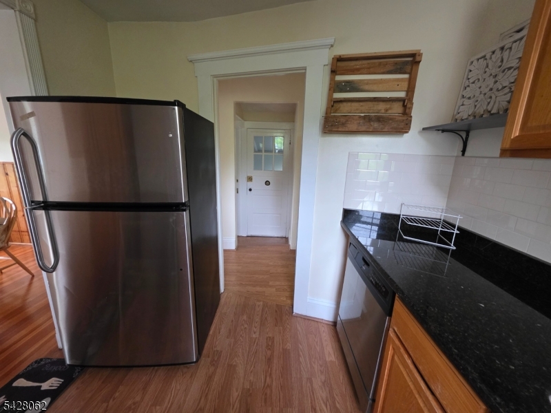 71 Montclair Avenue Montclair, NJ 07042 - Photo 7 of 25 a kitchen with a refrigerator and a wooden floor