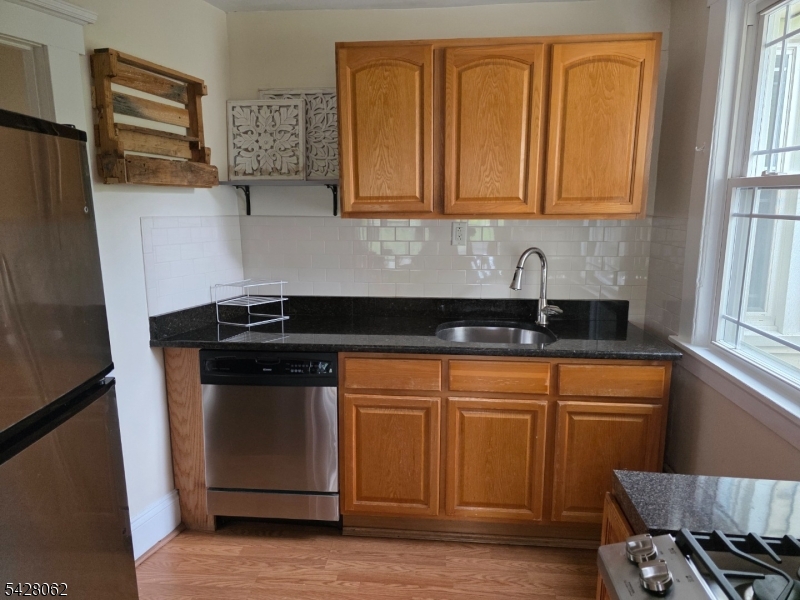 71 Montclair Avenue Montclair, NJ 07042 - Photo 8 of 25 a kitchen with stainless steel appliances granite countertop a sink stove and microwave