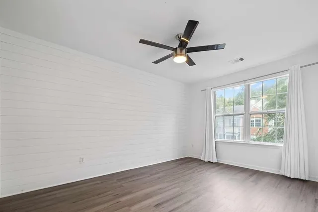 wooden floor in an empty room with a window