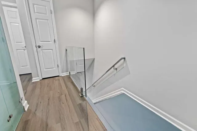 a view of a room with wooden floor