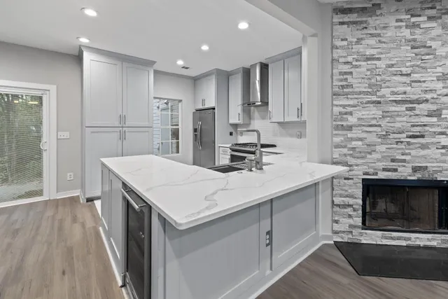 a kitchen with stainless steel appliances kitchen island a stove sink and cabinets
