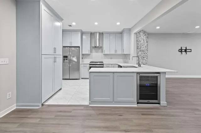 a kitchen with stainless steel appliances granite countertop a stove a sink and a refrigerator