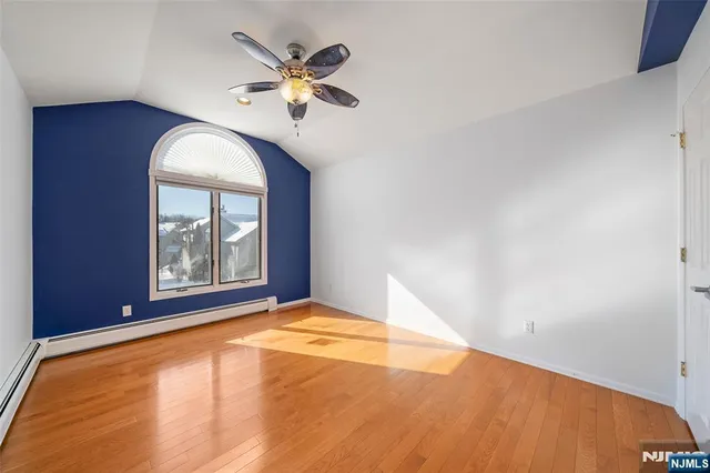 a view of a room with wooden floor and window