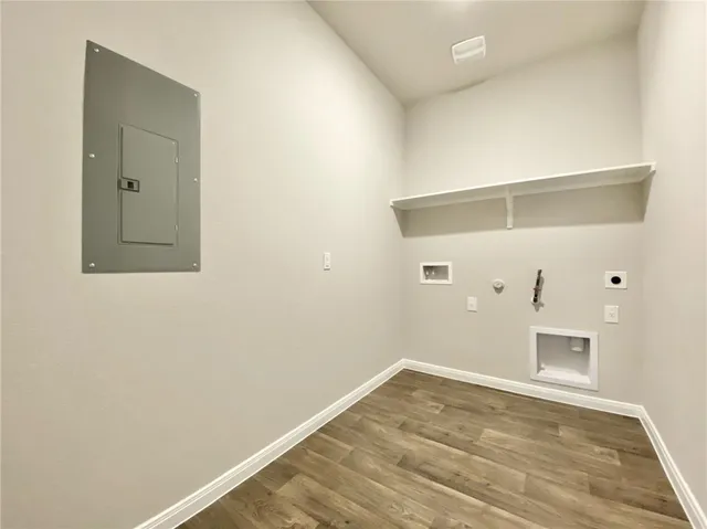 a view of a room with wooden floor and white wall