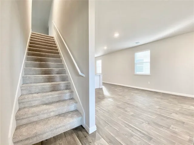 a view of entryway and hall with wooden floor