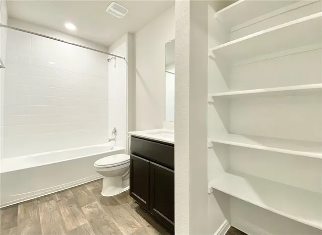 a bathroom with a toilet a sink and bathtub