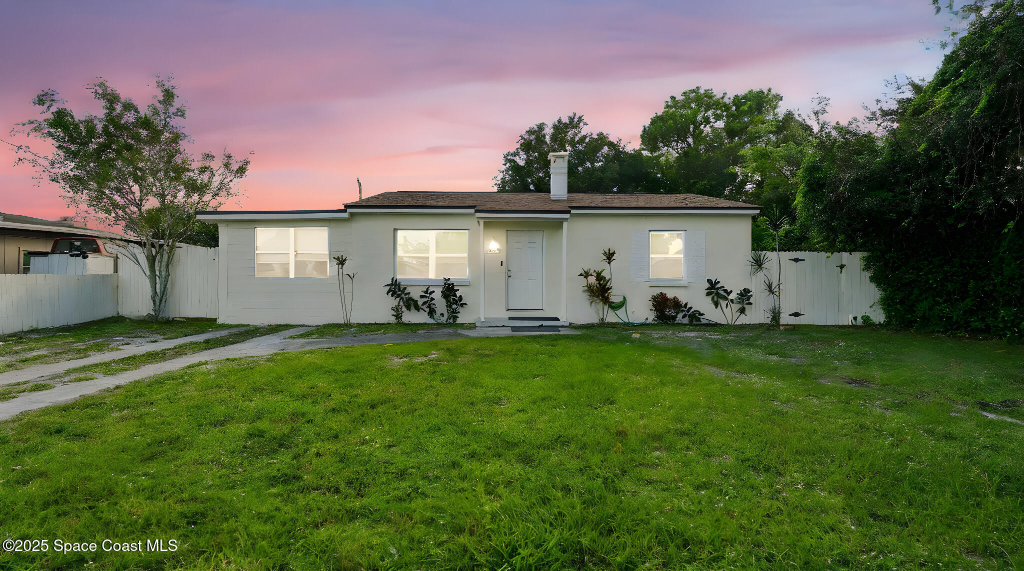 a front view of house with yard and outdoor seating