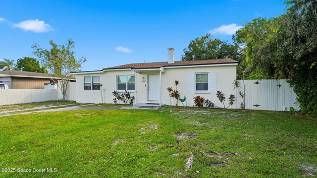 a view of yard with swimming pool and sitting area