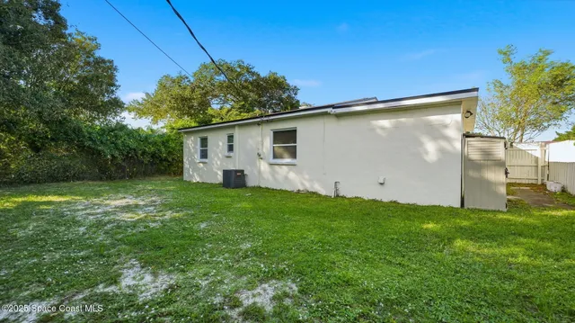 a view of a backyard with a garden and entertaining space