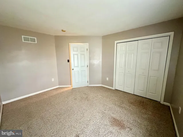 a view of an empty room and entryway