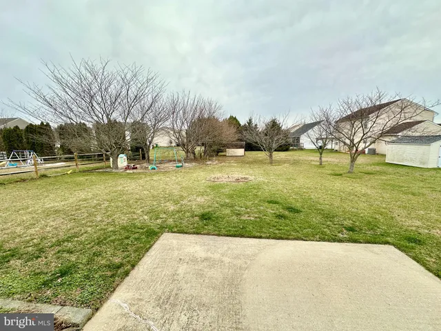 a view of yard with swimming pool and trees