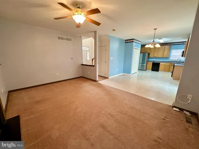 a view of a kitchen with a sink and a refrigerator