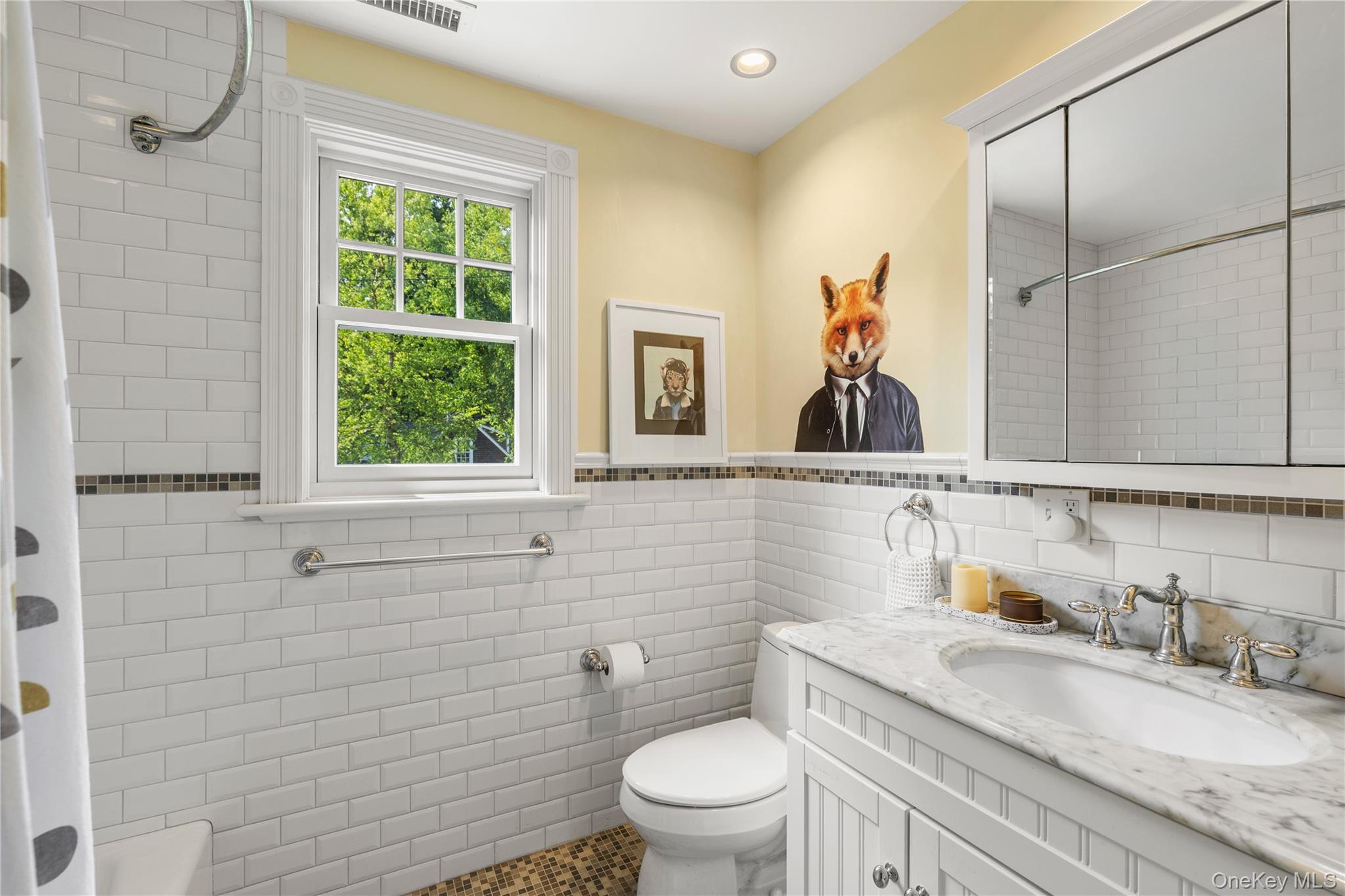 12 Kenmare Road Larchmont, NY 10538 - Photo 21 of 36 The bright hall bathroom has a shower/tub combination and under the sink storage.