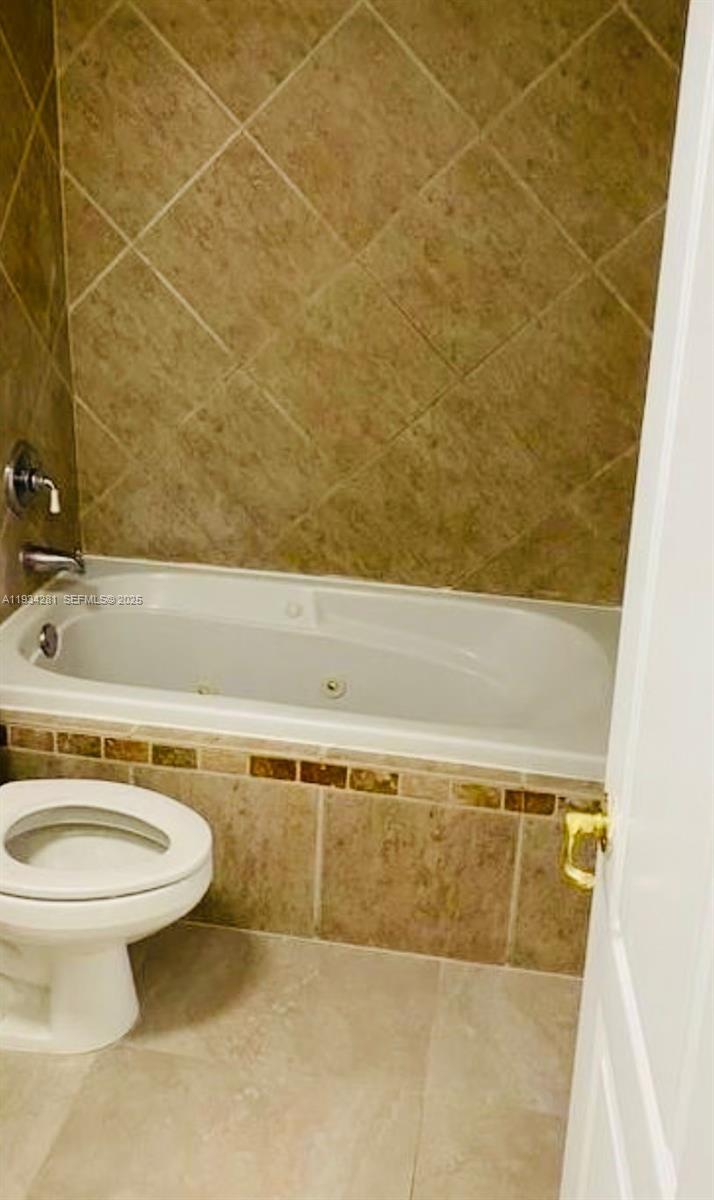 4803 Northwest 7th Street, Unit 21014 Miami, FL 33126 - Photo 4 of 15 a bathroom with a sink and a toilet