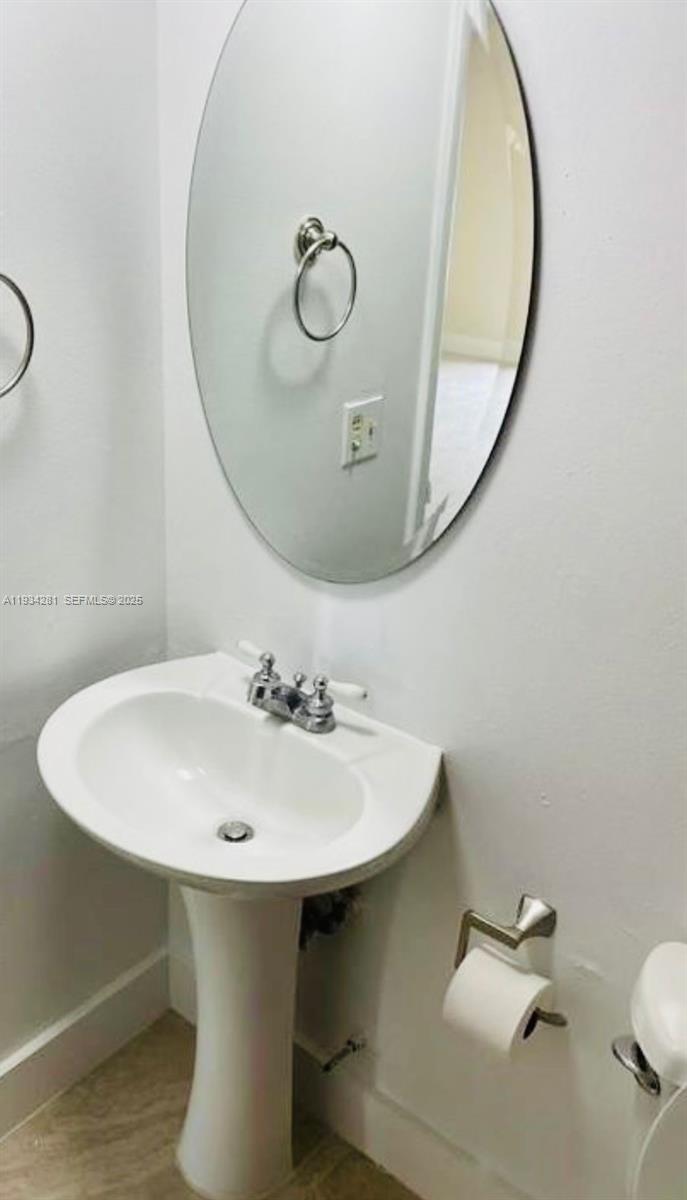 4803 Northwest 7th Street, Unit 21014 Miami, FL 33126 - Photo 6 of 15 a bathroom with a sink and mirror