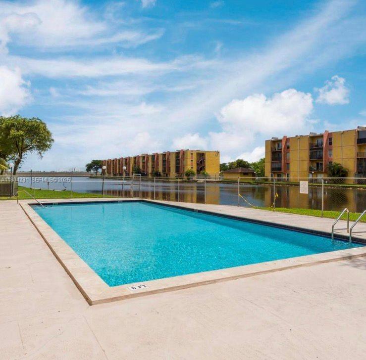 4803 Northwest 7th Street, Unit 21014 Miami, FL 33126 - Photo 10 of 15 a view of a swimming pool and an outdoor seating