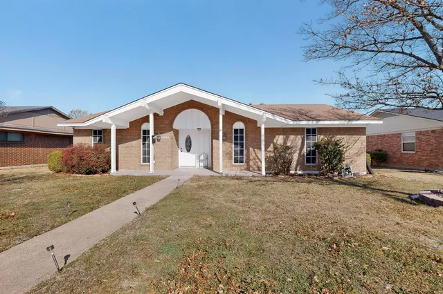 a kitchen with stainless steel appliances granite countertop a refrigerator a stove a sink and a granite counter tops