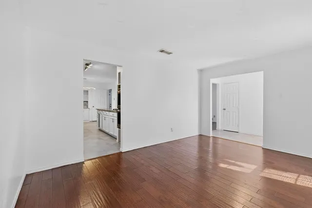 an empty room with fan and entrance