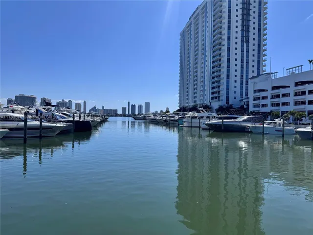 a front view of a house with cars parked