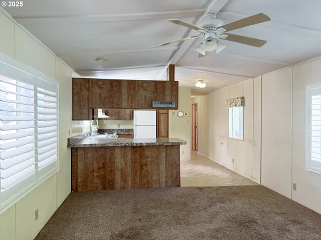 a view of kitchen with stainless steel appliances granite countertop cabinets and outdoor space