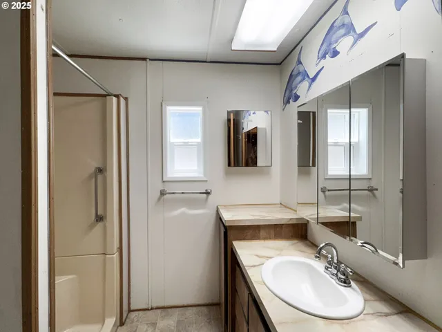 a bathroom with a sink double vanity and a mirror