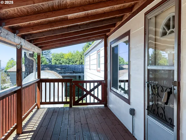a view of a porch with wooden floor and outdoor seating