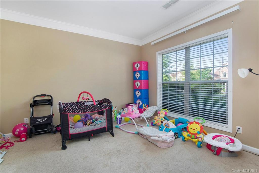 10529 Greenhead View Road Charlotte, NC 28262 - Photo 11 of 32 a bedroom with toys and a baby crib