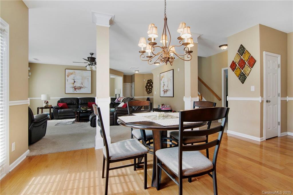 10529 Greenhead View Road Charlotte, NC 28262 - Photo 15 of 32 a view of a dining room with furniture and wooden floor