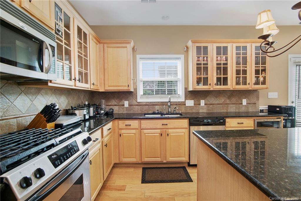 10529 Greenhead View Road Charlotte, NC 28262 - Photo 18 of 32 a kitchen with stainless steel appliances granite countertop a stove and a sink