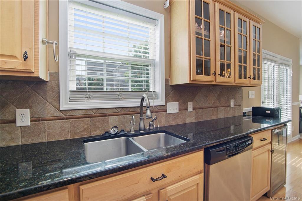 10529 Greenhead View Road Charlotte, NC 28262 - Photo 19 of 32 a kitchen with granite countertop a sink and a counter top space