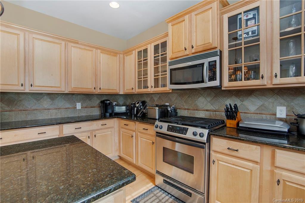 10529 Greenhead View Road Charlotte, NC 28262 - Photo 20 of 32 a kitchen with stainless steel appliances granite countertop a stove and cabinets