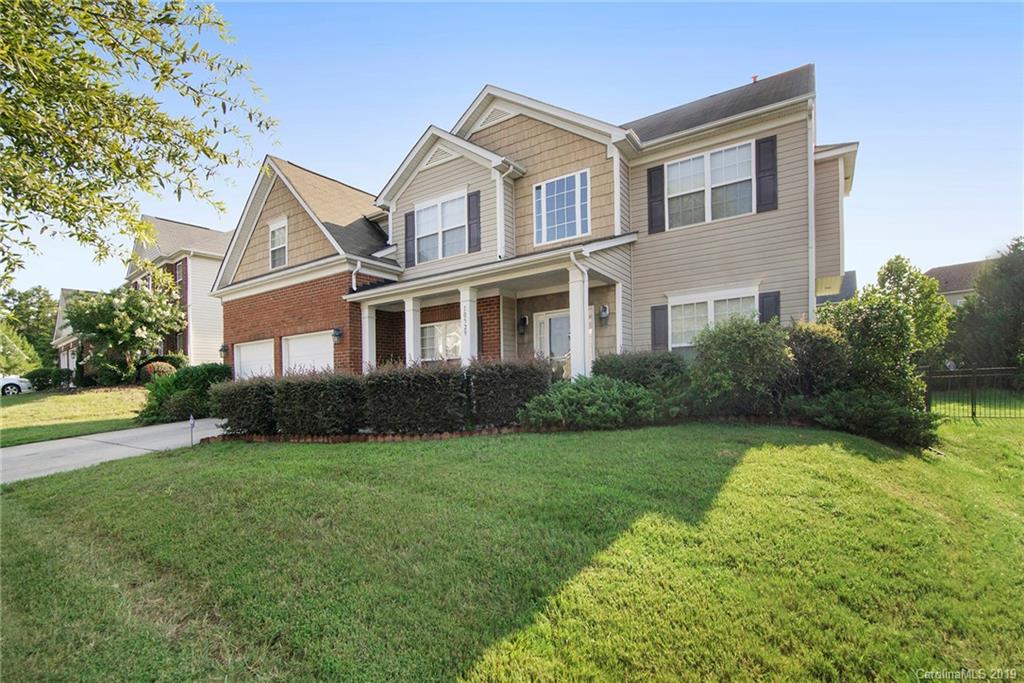 10529 Greenhead View Road Charlotte, NC 28262 - Photo 3 of 32 a front view of a house with garden and trees