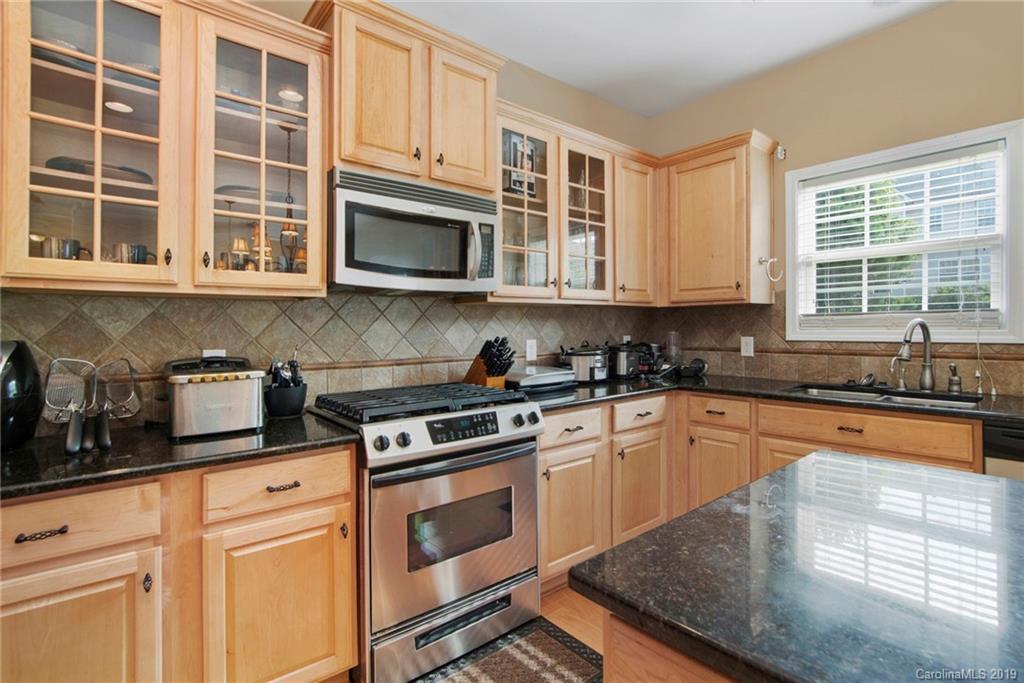 10529 Greenhead View Road Charlotte, NC 28262 - Photo 21 of 32 a kitchen with stainless steel appliances granite countertop a stove a sink and a microwave