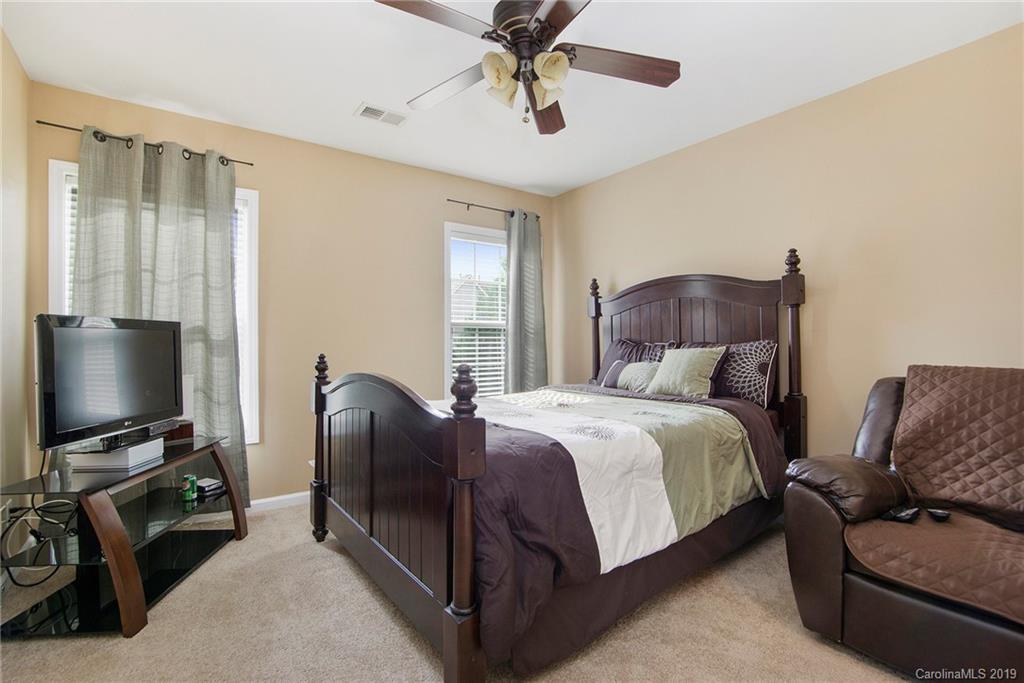 10529 Greenhead View Road Charlotte, NC 28262 - Photo 22 of 32 a bedroom with a bed and a flat screen tv