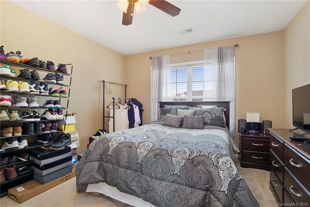 10529 Greenhead View Road Charlotte, NC 28262 - Photo 24 of 32 a bedroom with a bed and a bookshelf