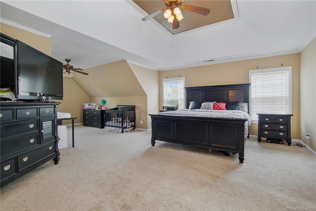 10529 Greenhead View Road Charlotte, NC 28262 - Photo 27 of 32 a bedroom with furniture and a flat screen tv