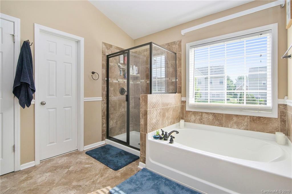 10529 Greenhead View Road Charlotte, NC 28262 - Photo 29 of 32 a bathroom with a bathtub and a shower