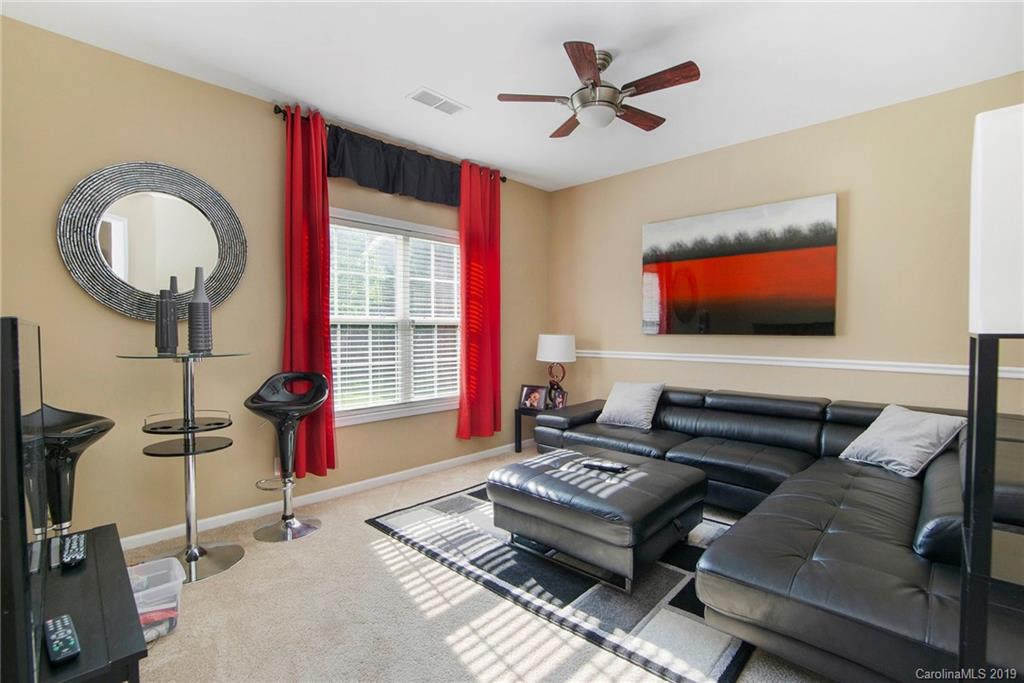 10529 Greenhead View Road Charlotte, NC 28262 - Photo 9 of 32 a living room with furniture a flat screen tv and a window