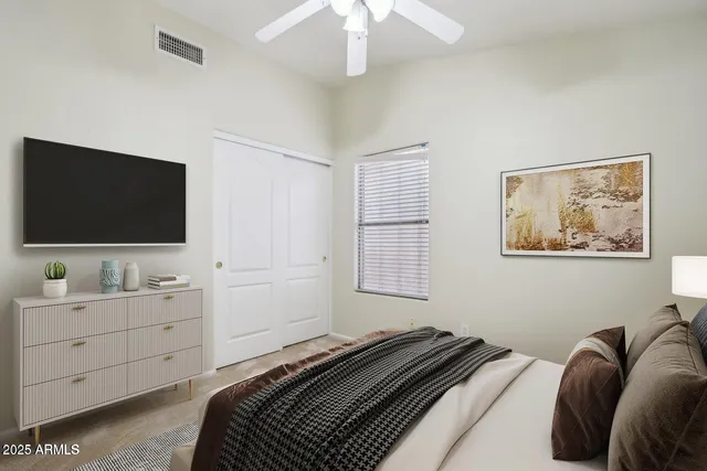 a bedroom with a bed and a flat screen tv