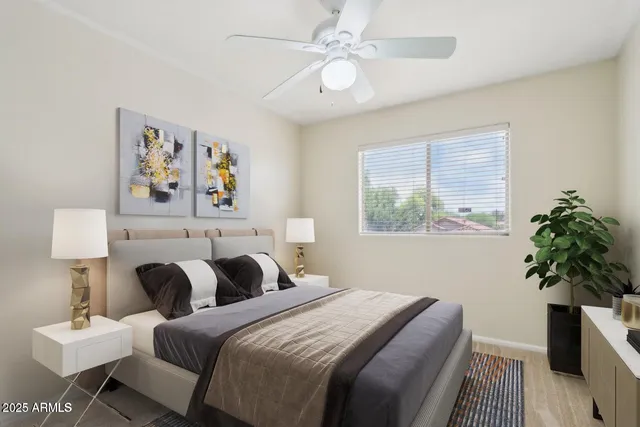 a bedroom with a bed and a potted plant