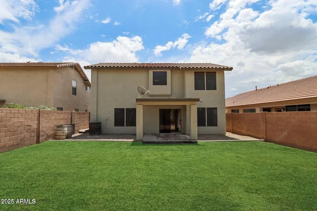 a front view of a house with a garden and yard