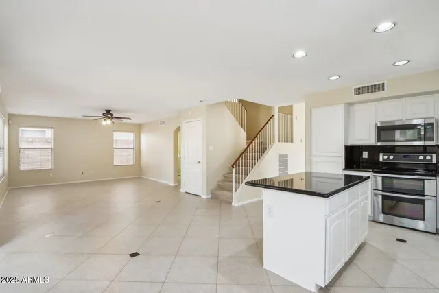 a kitchen with stainless steel appliances granite countertop a sink and a stove