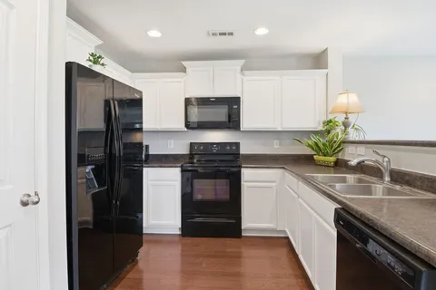 a kitchen with a refrigerator and a sink