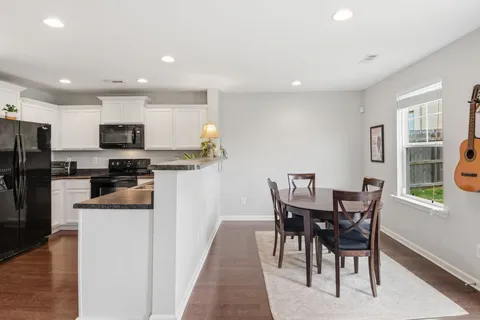 a view of a dining room with furniture and a kitchen