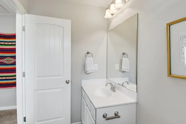 a bathroom with a sink a mirror and shower