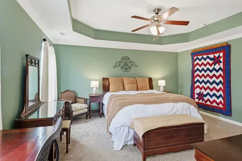 a bedroom with a bed and a chandelier