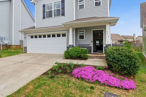 a front view of a house with yard