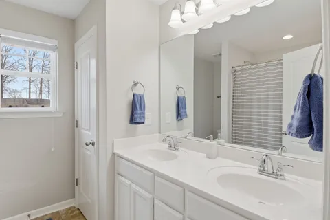 a bathroom with 2 sink and a mirror