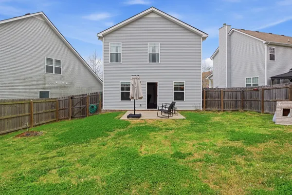 a view of house with backyard and porch